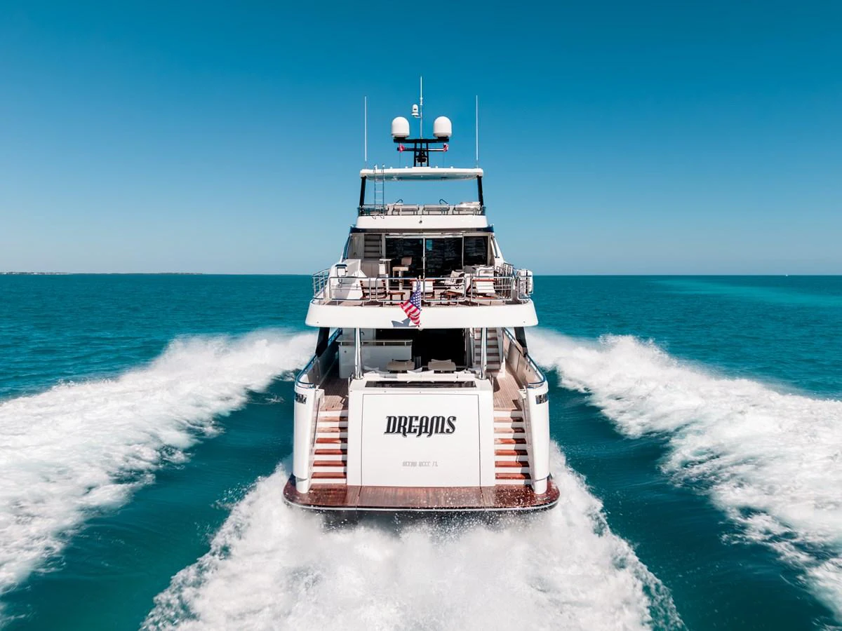 A luxurious yacht cruising through clear blue waters, leaving a trail of white waves behind. aboard OCEAN ALEXANDER 37L/01 Yacht for Sale