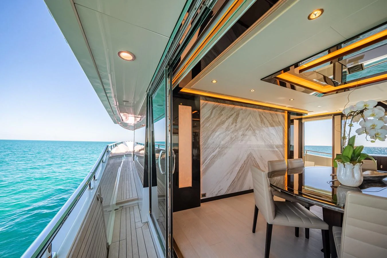 This image showcases a luxurious dining area on a yacht with a stunning view of the sea. aboard OCEAN ALEXANDER 37L/01 Yacht for Sale