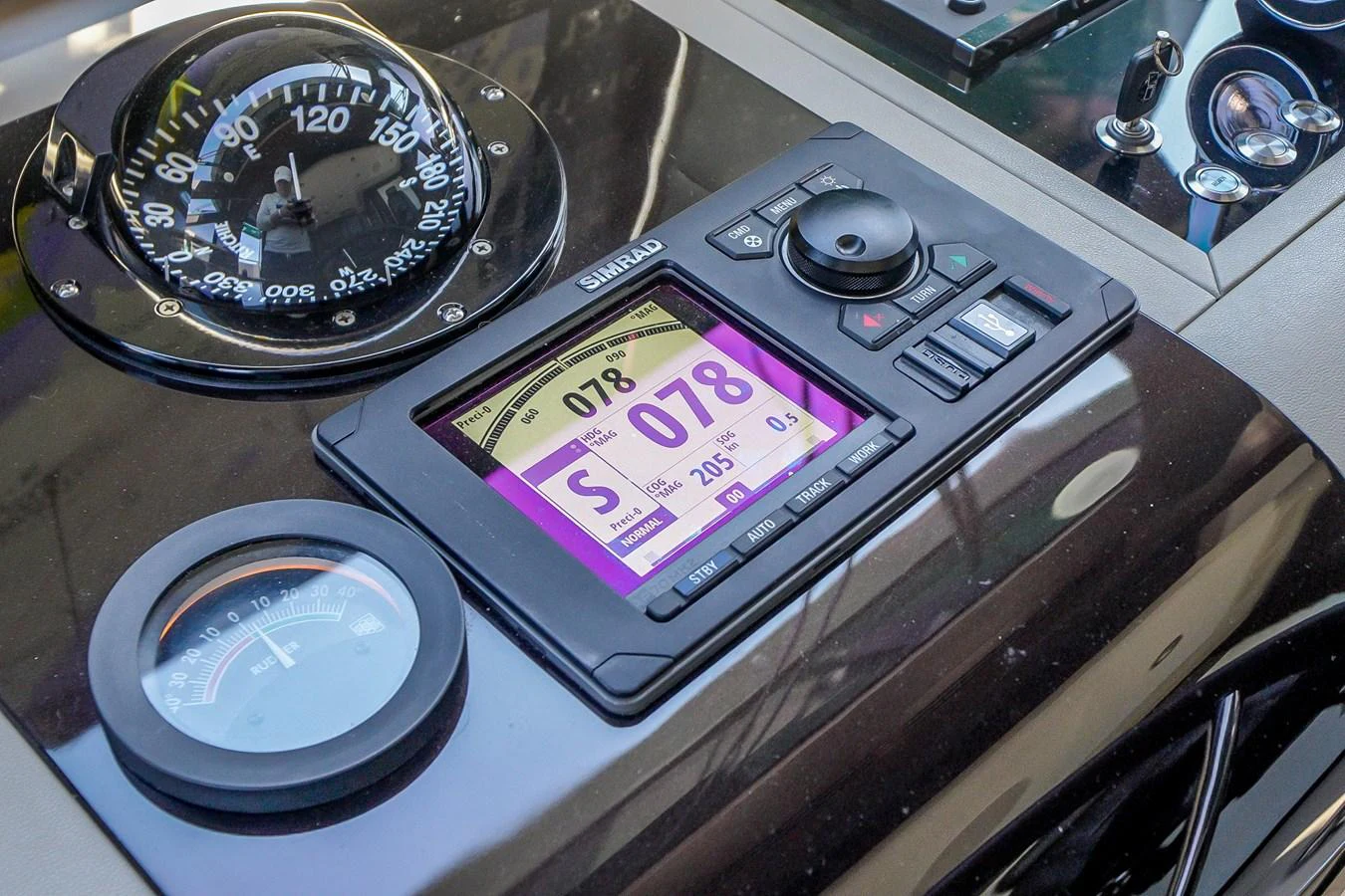 A close-up view of the yacht's helm showcasing advanced navigation instruments. aboard OCEAN ALEXANDER 37L/01 Yacht for Sale