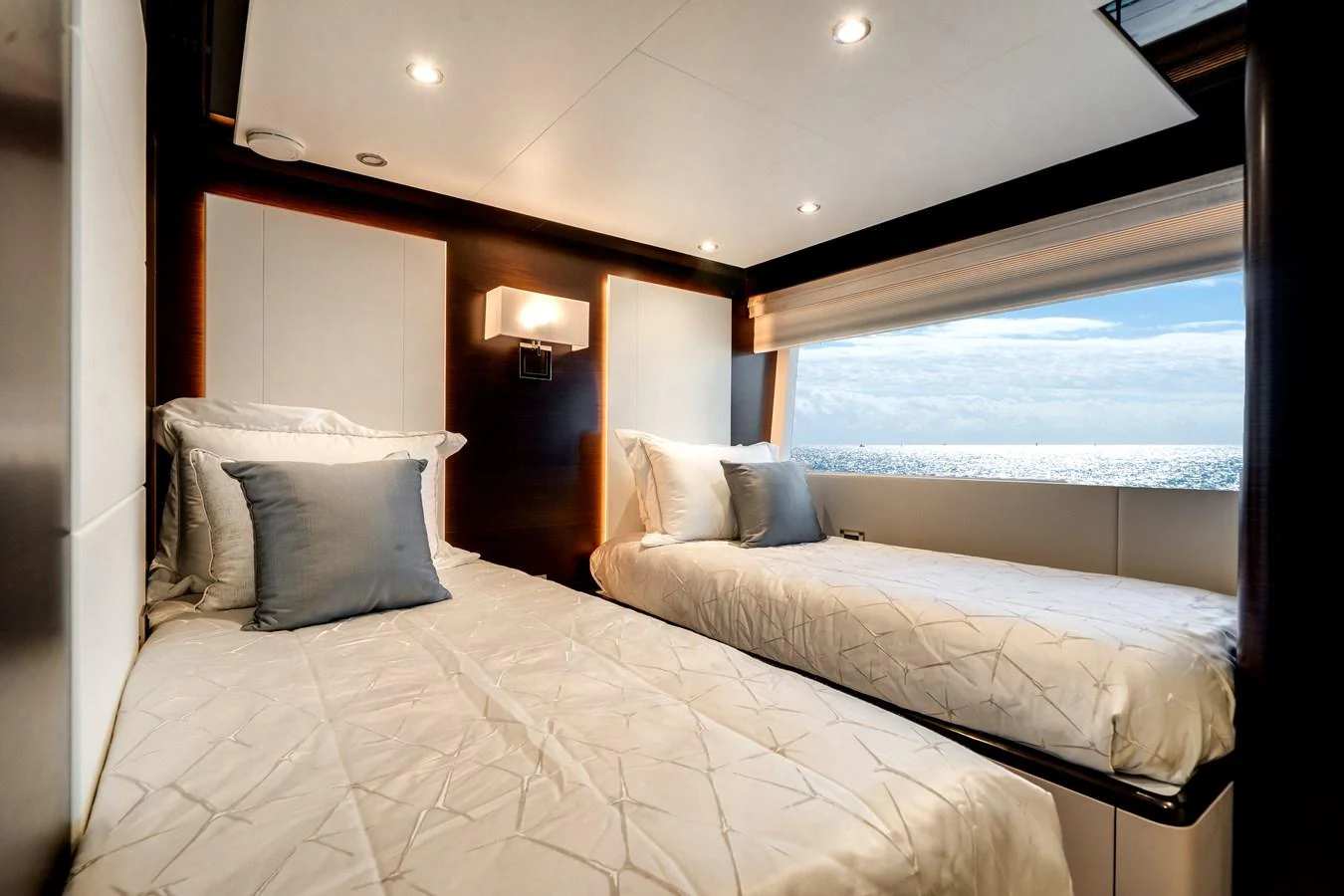 The guest stateroom features twin beds with a large window offering a stunning ocean view. aboard OCEAN ALEXANDER 37L/01 Yacht for Sale