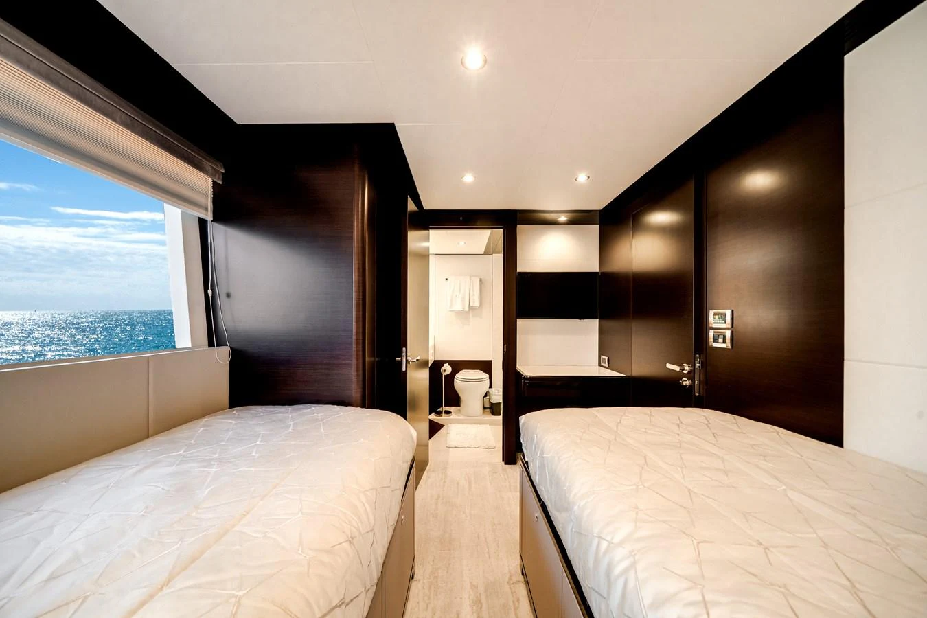 The guest stateroom features twin beds and a view of the sea through a large window. aboard OCEAN ALEXANDER 37L/01 Yacht for Sale