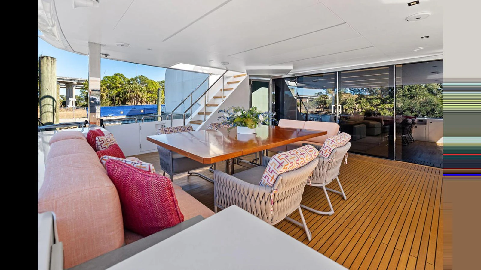 a living room with a table and chairs aboard MOBILLITY Yacht for Sale