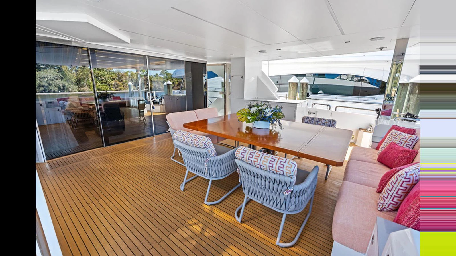 a living room with a table and chairs aboard MOBILLITY Yacht for Sale