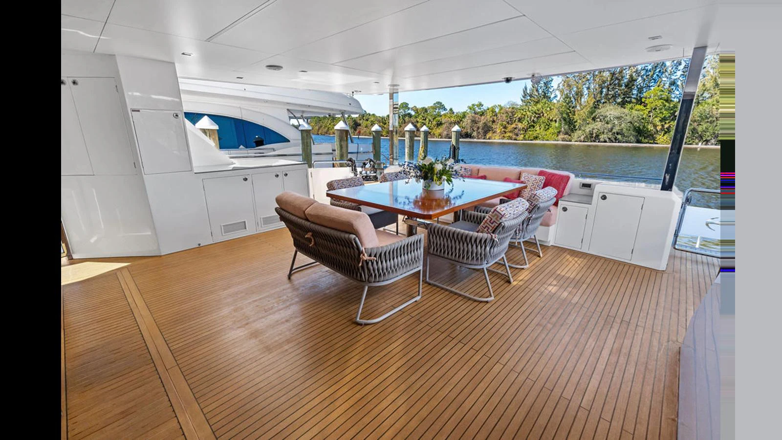 a large open area with a table and chairs and a large window aboard MOBILLITY Yacht for Sale