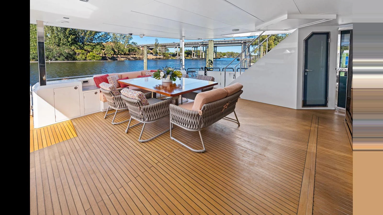 a room with a table chairs and a pool aboard MOBILLITY Yacht for Sale
