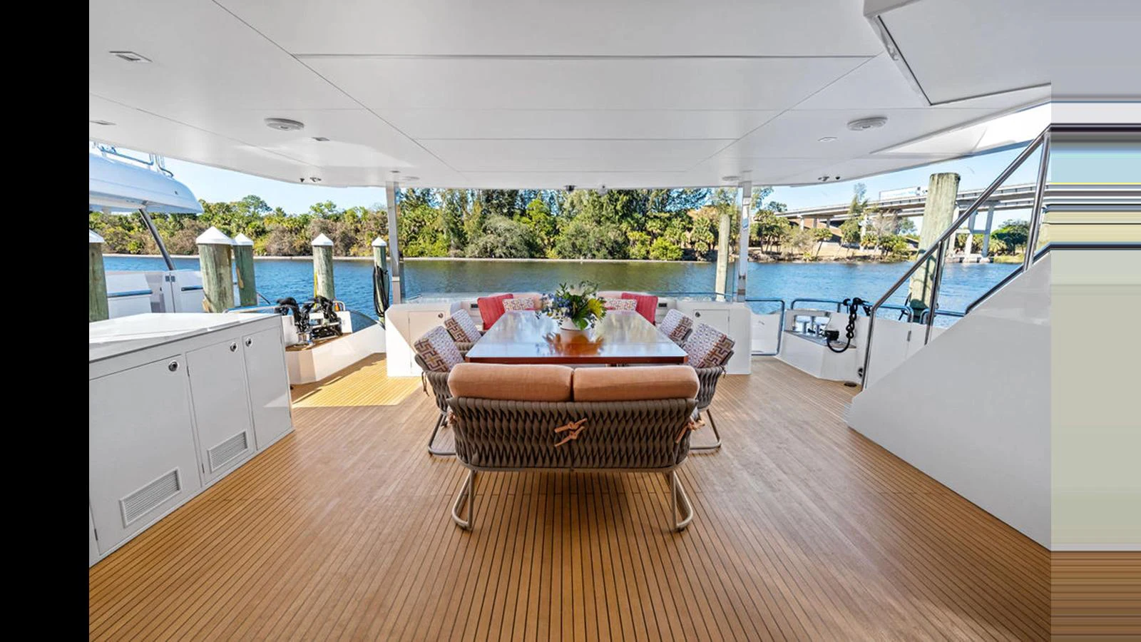a living room with a table and chairs aboard MOBILLITY Yacht for Sale