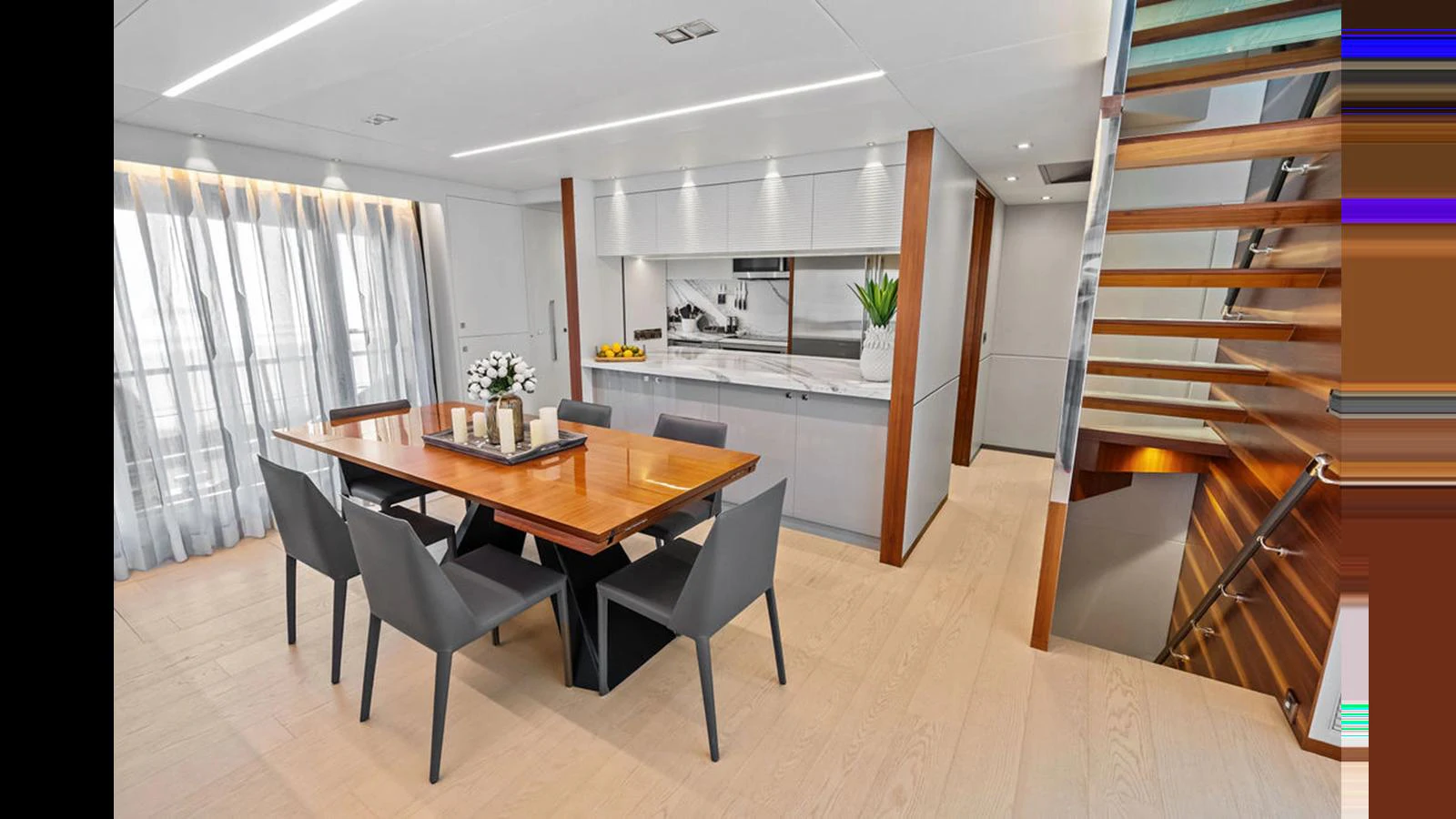 a dining table and chairs in a room with a window aboard MOBILLITY Yacht for Sale