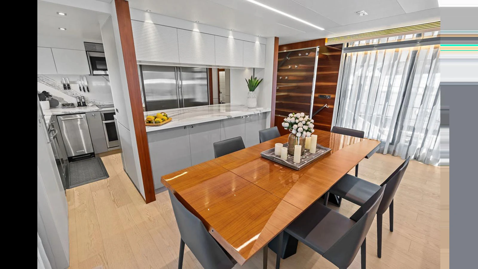 a kitchen with a table and chairs aboard MOBILLITY Yacht for Sale