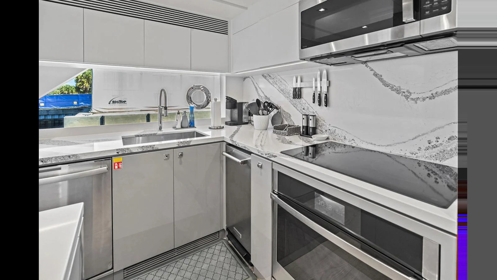 a kitchen with white cabinets aboard MOBILLITY Yacht for Sale