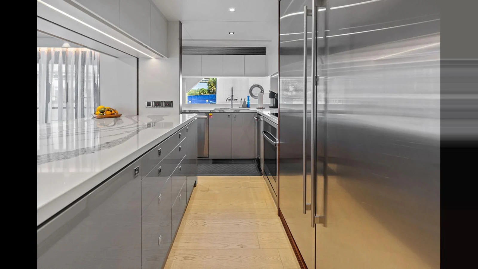 a kitchen with stainless steel appliances aboard MOBILLITY Yacht for Sale