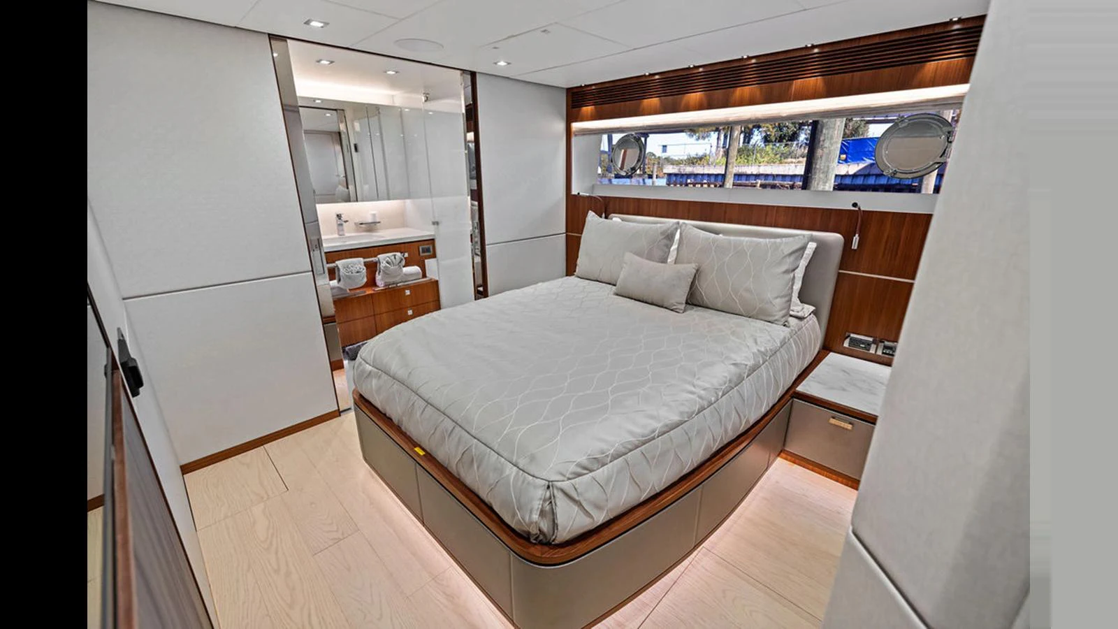 a bedroom with a bed and a desk aboard MOBILLITY Yacht for Sale