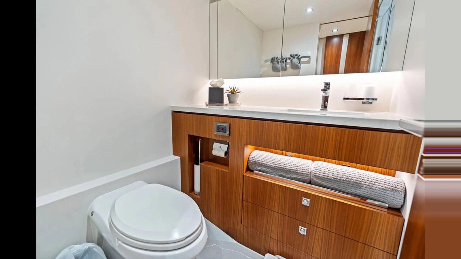 a bathroom with a toilet and a mirror aboard MOBILLITY Yacht for Sale