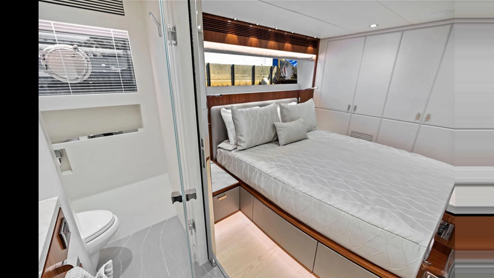 a bedroom with a bed and a mirror aboard MOBILLITY Yacht for Sale