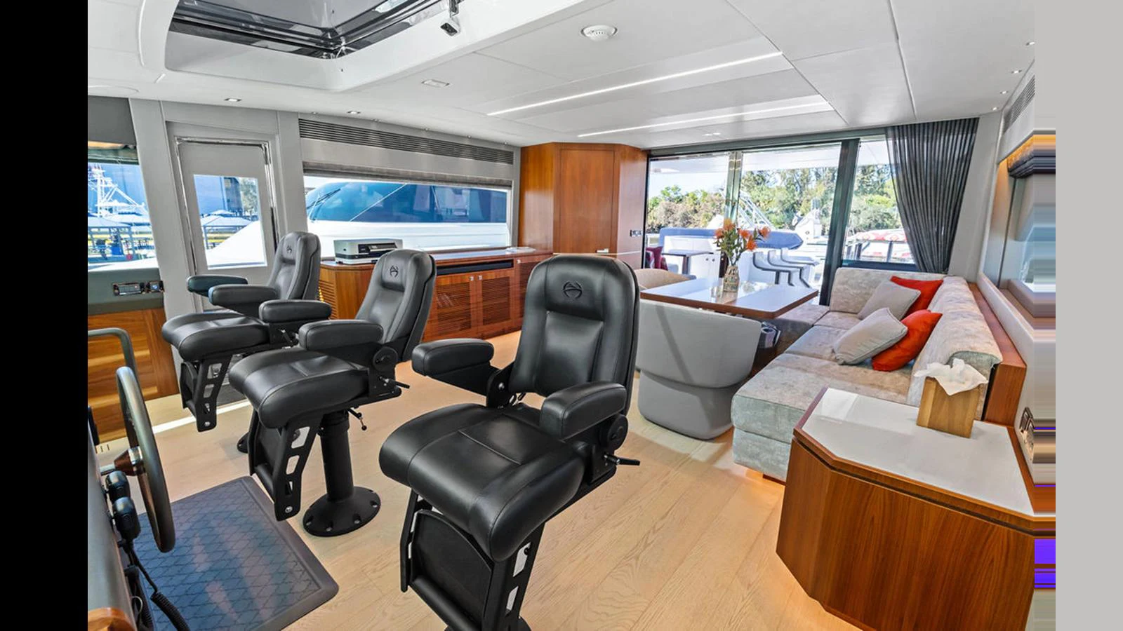 a room with a table chairs and a couch aboard MOBILLITY Yacht for Sale