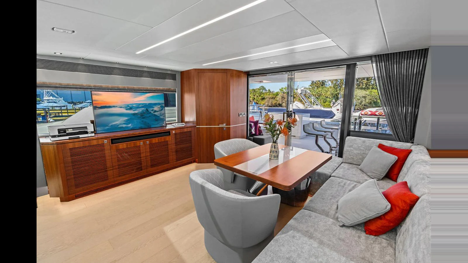 a living room with a large screen aboard MOBILLITY Yacht for Sale