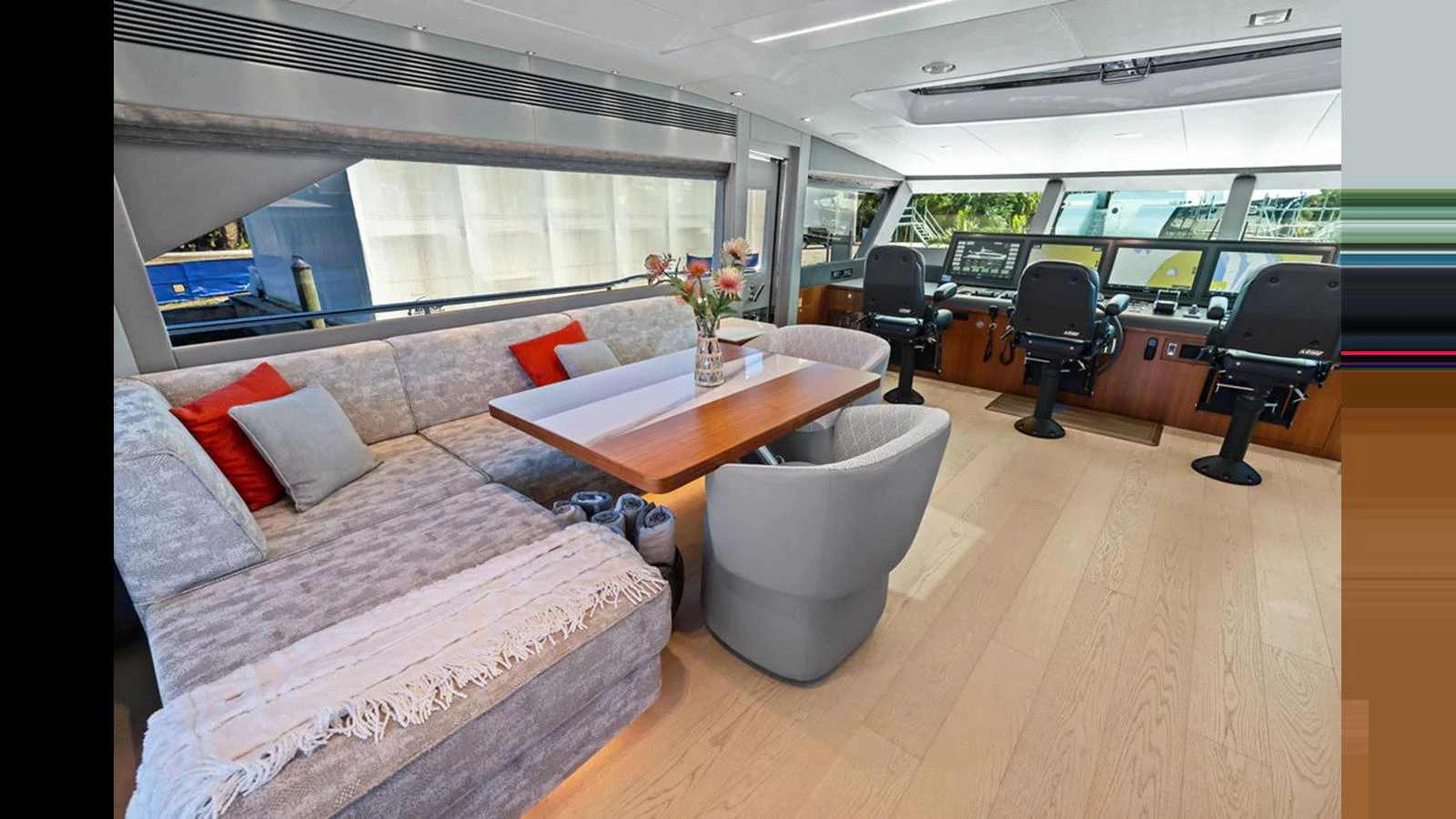 a room with a couch and a table and chairs aboard MOBILLITY Yacht for Sale