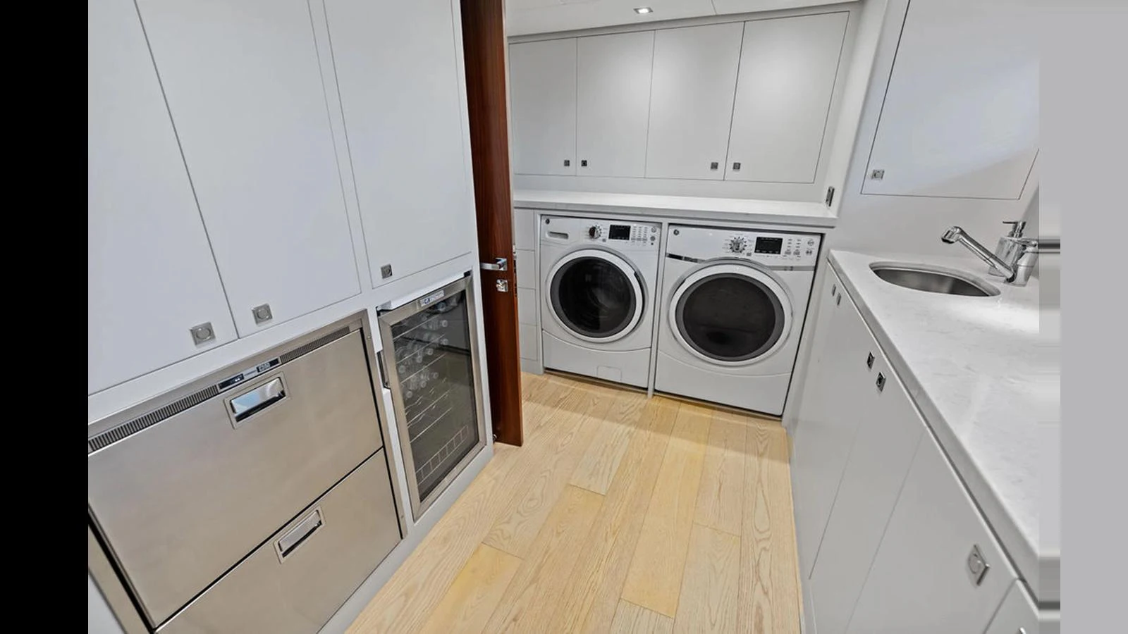 a kitchen with white cabinets aboard MOBILLITY Yacht for Sale