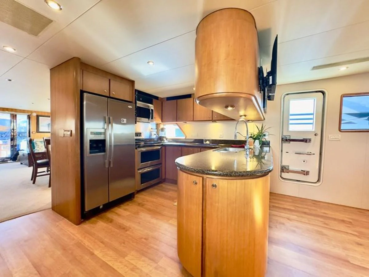 The yacht's galley features modern appliances and a spacious layout with warm wooden finishes. aboard BREAKAWAY Yacht for Sale