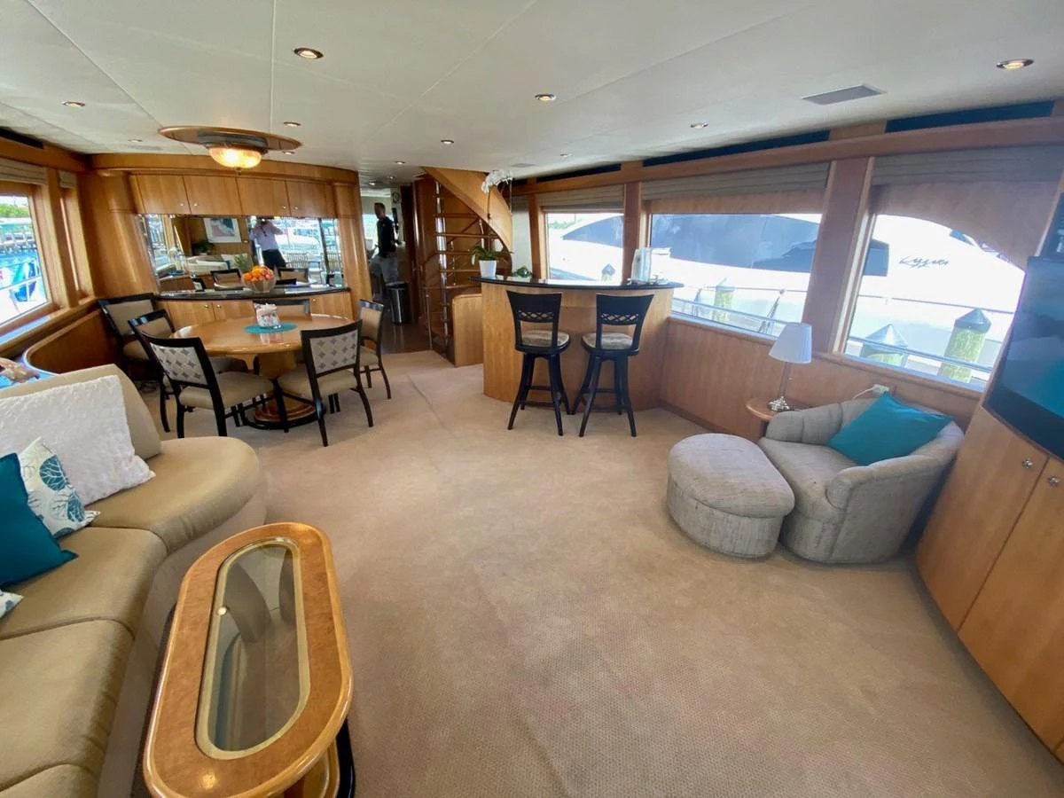 The yacht's salon features comfortable seating and a dining area with large windows providing ample natural light. aboard BREAKAWAY Yacht for Sale