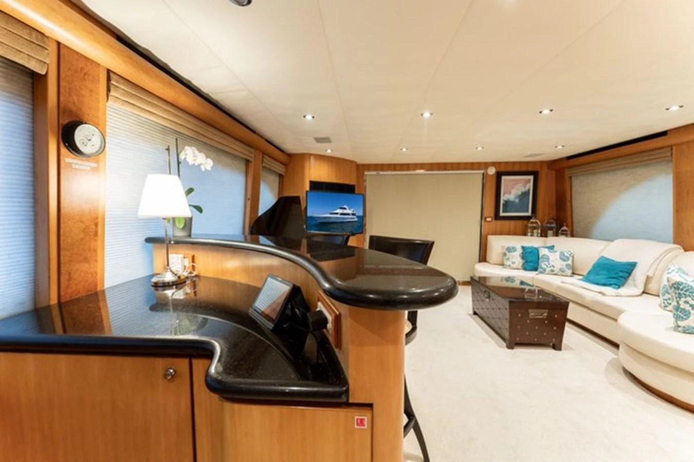 The salon features elegant furnishings with a cozy seating area and a stylish bar. aboard BREAKAWAY Yacht for Sale