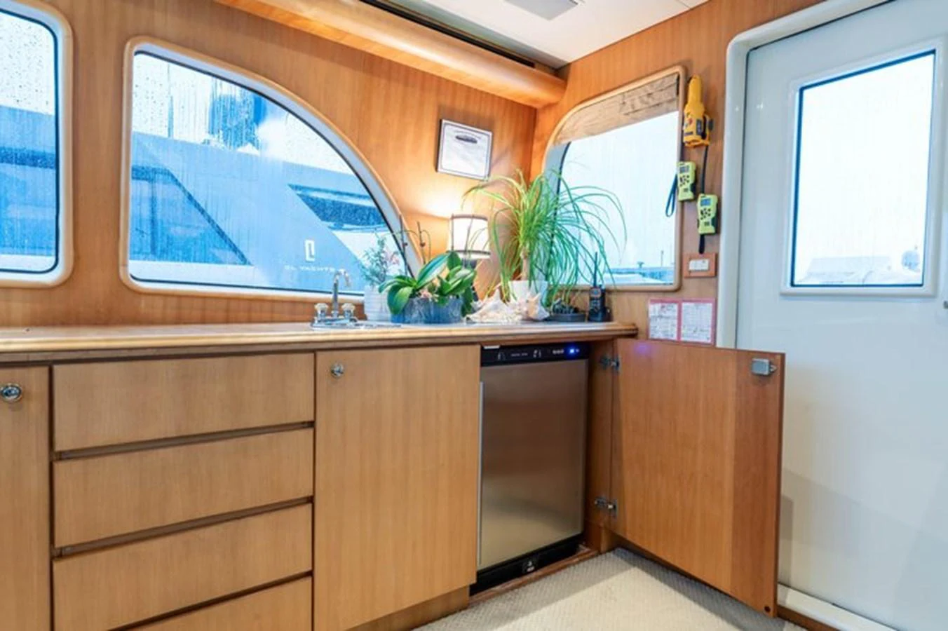 The yacht's galley features wooden cabinetry, a dishwasher, and ample natural light. aboard BREAKAWAY Yacht for Sale