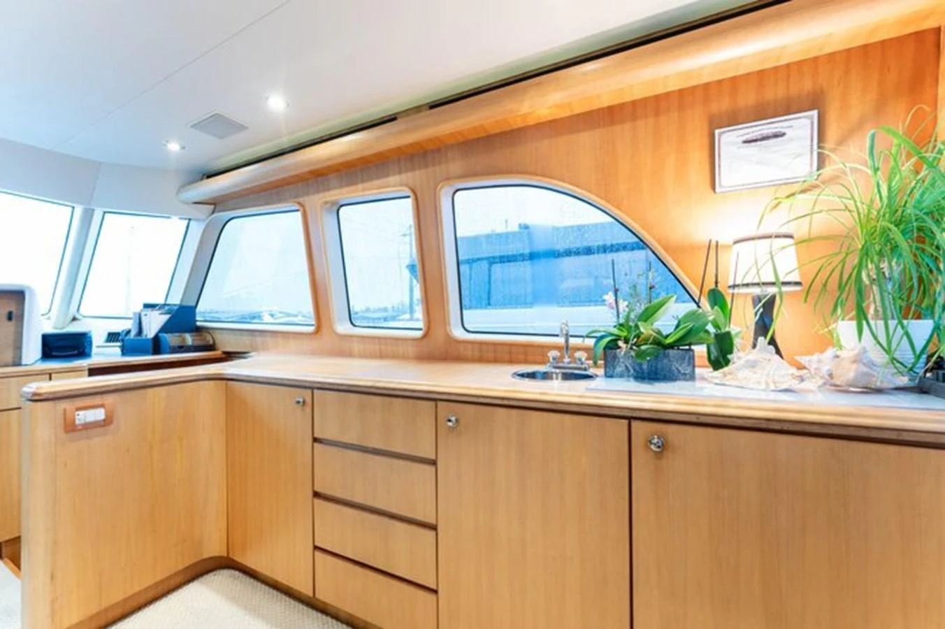 The galley features sleek wooden cabinetry and large windows for ample natural light. aboard BREAKAWAY Yacht for Sale