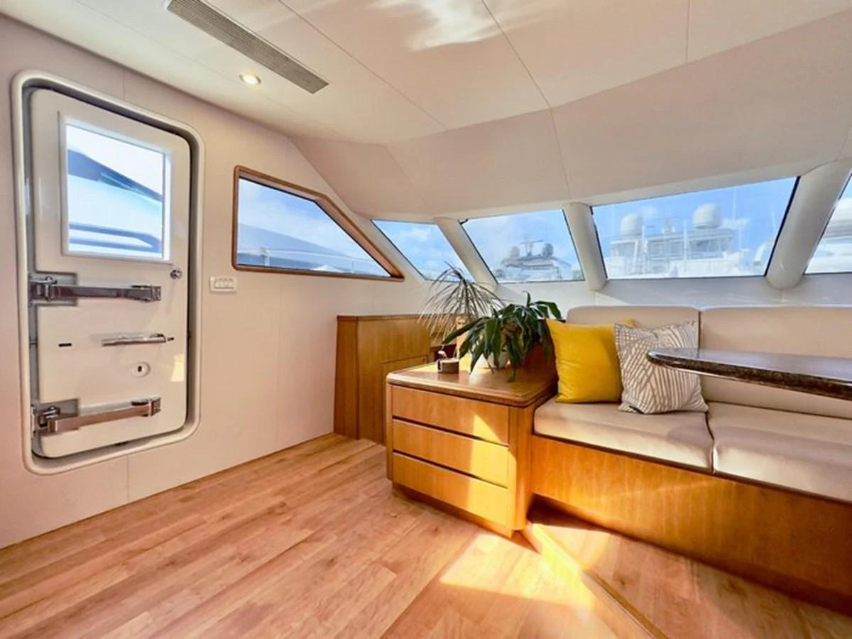 A cozy interior seating area with large windows and natural light. aboard BREAKAWAY Yacht for Sale