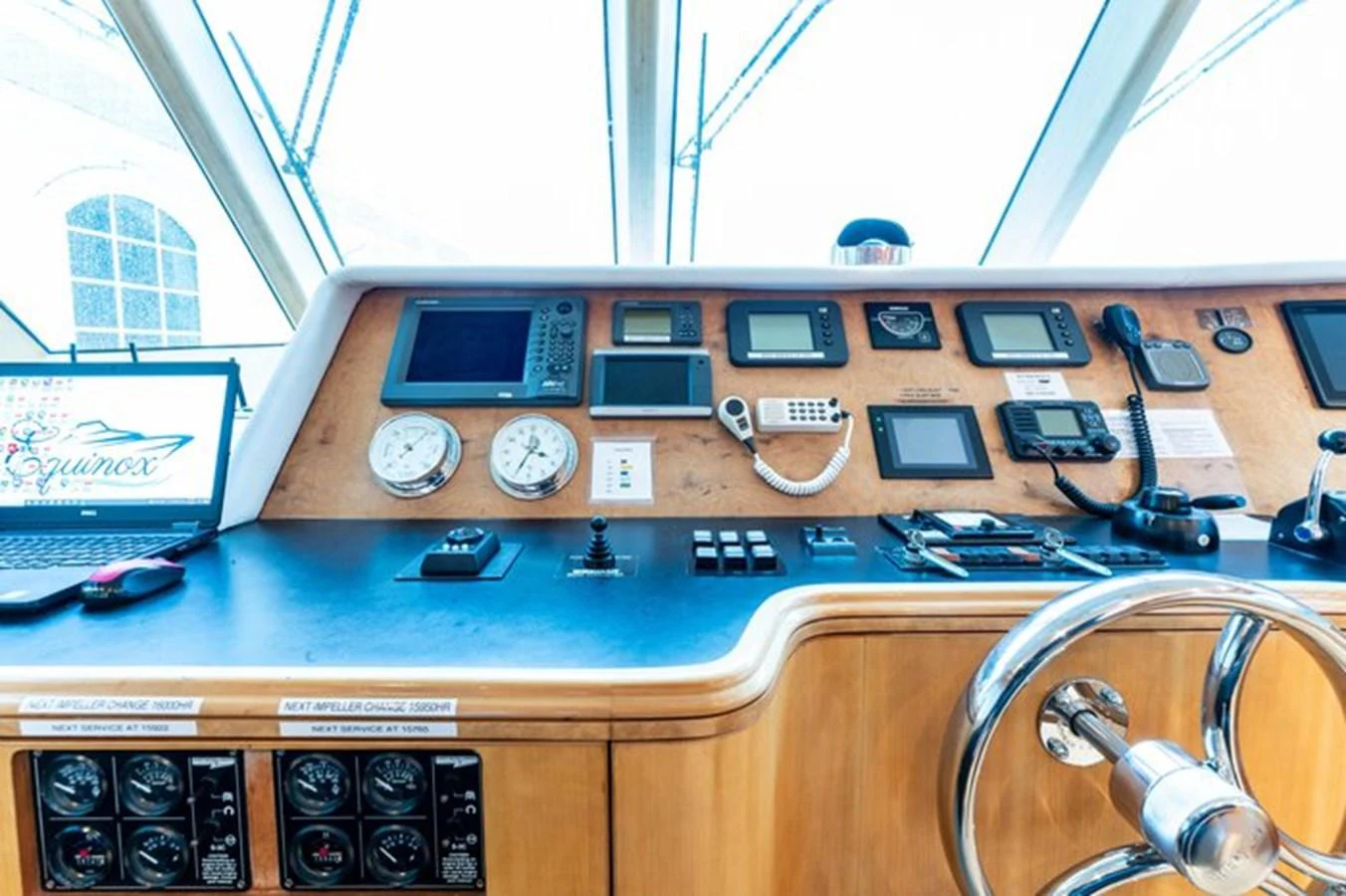 The helm station features advanced navigation equipment and a sleek design. aboard BREAKAWAY Yacht for Sale