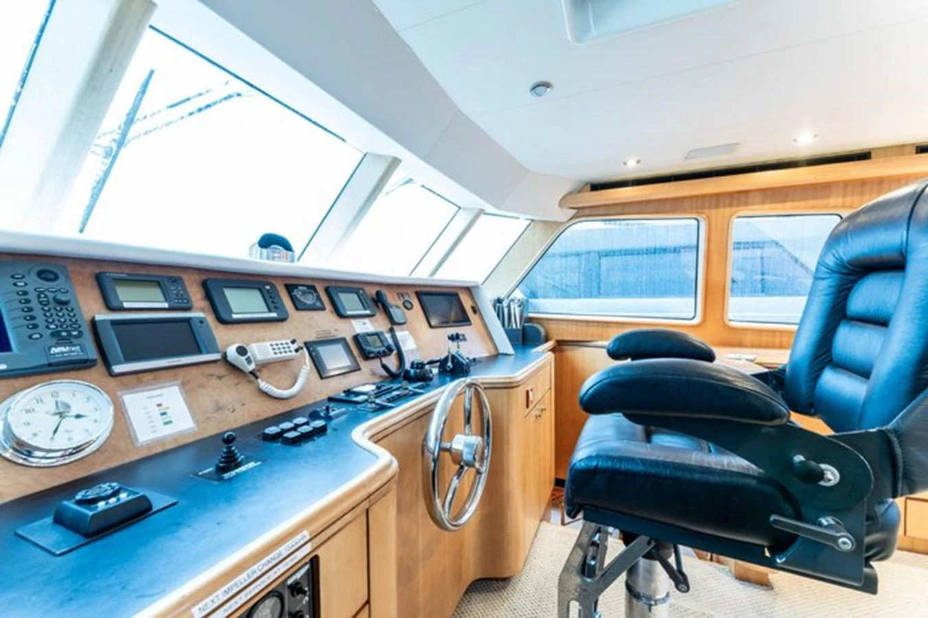 The helm station features advanced navigation equipment and a comfortable captain's chair. aboard BREAKAWAY Yacht for Sale