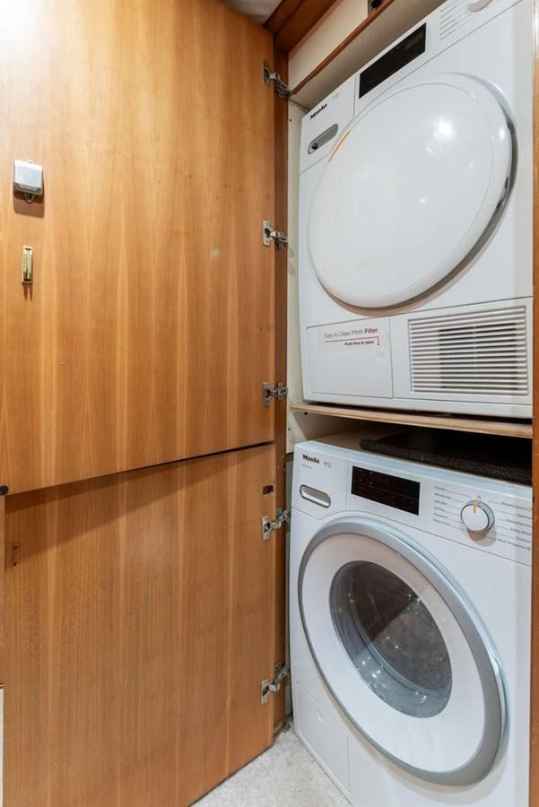 The yacht features a compact and efficient laundry area with modern appliances. aboard BREAKAWAY Yacht for Sale