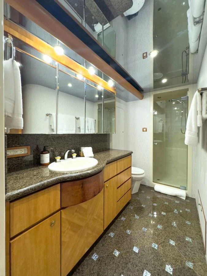 The yacht's bathroom features elegant cabinetry, a sleek countertop, and a spacious shower area. aboard BREAKAWAY Yacht for Sale