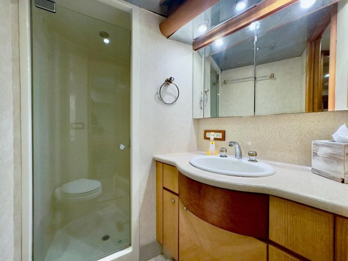 The yacht's bathroom features a sleek design with a glass-enclosed shower and modern fixtures. aboard BREAKAWAY Yacht for Sale