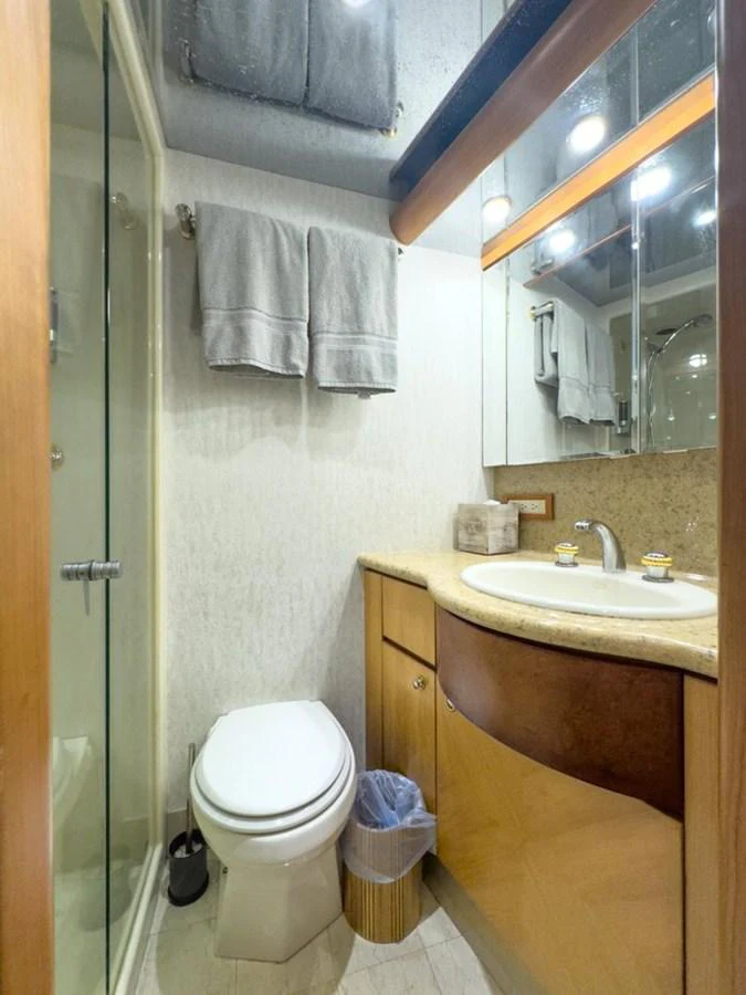 The yacht's bathroom features a sleek design with a glass-enclosed shower and modern fixtures. aboard BREAKAWAY Yacht for Sale
