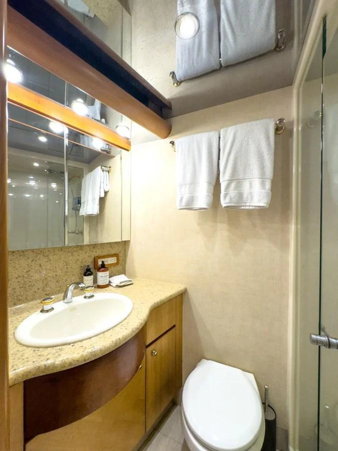 The yacht's bathroom features a sleek design with a modern sink and a glass-enclosed shower. aboard BREAKAWAY Yacht for Sale