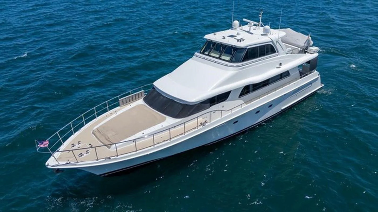A sleek and modern yacht cruising on the open water, showcasing its elegant design and spacious deck. aboard BREAKAWAY Yacht for Sale