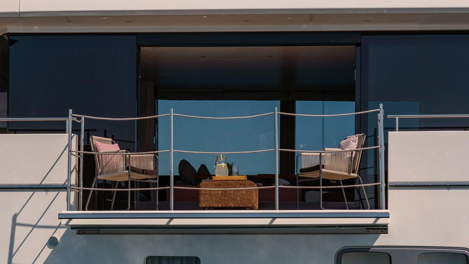 A stylish balcony area with comfortable seating and a table, perfect for enjoying the view. aboard JOURNEY Yacht for Sale