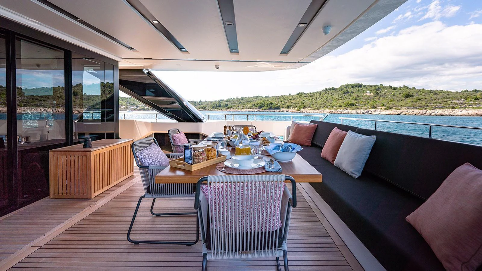 The aft deck offers a stylish dining area with a stunning view of the sea. aboard JOURNEY Yacht for Sale