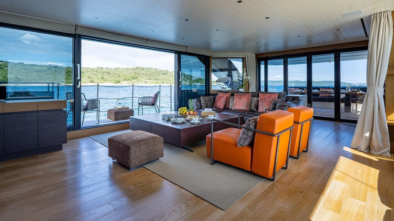 The spacious salon features modern furnishings and large windows offering stunning views of the water. aboard JOURNEY Yacht for Sale