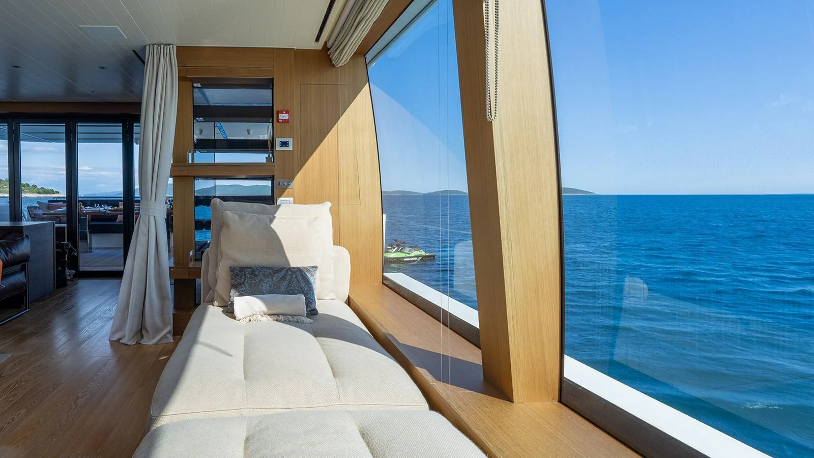 A serene lounge area with panoramic ocean views through large windows. aboard JOURNEY Yacht for Sale