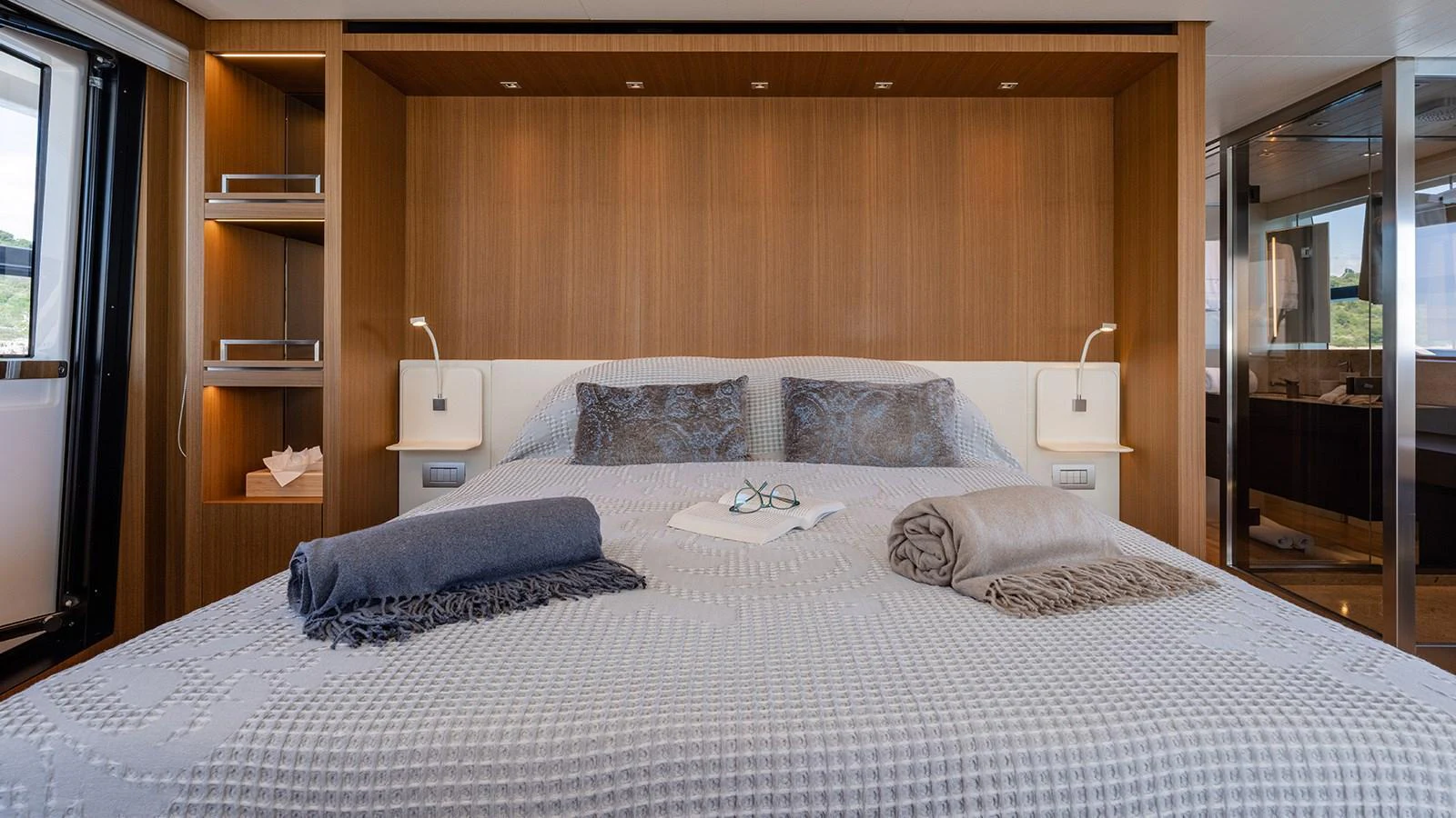 The master stateroom features a spacious bed with elegant bedding and modern lighting. aboard JOURNEY Yacht for Sale