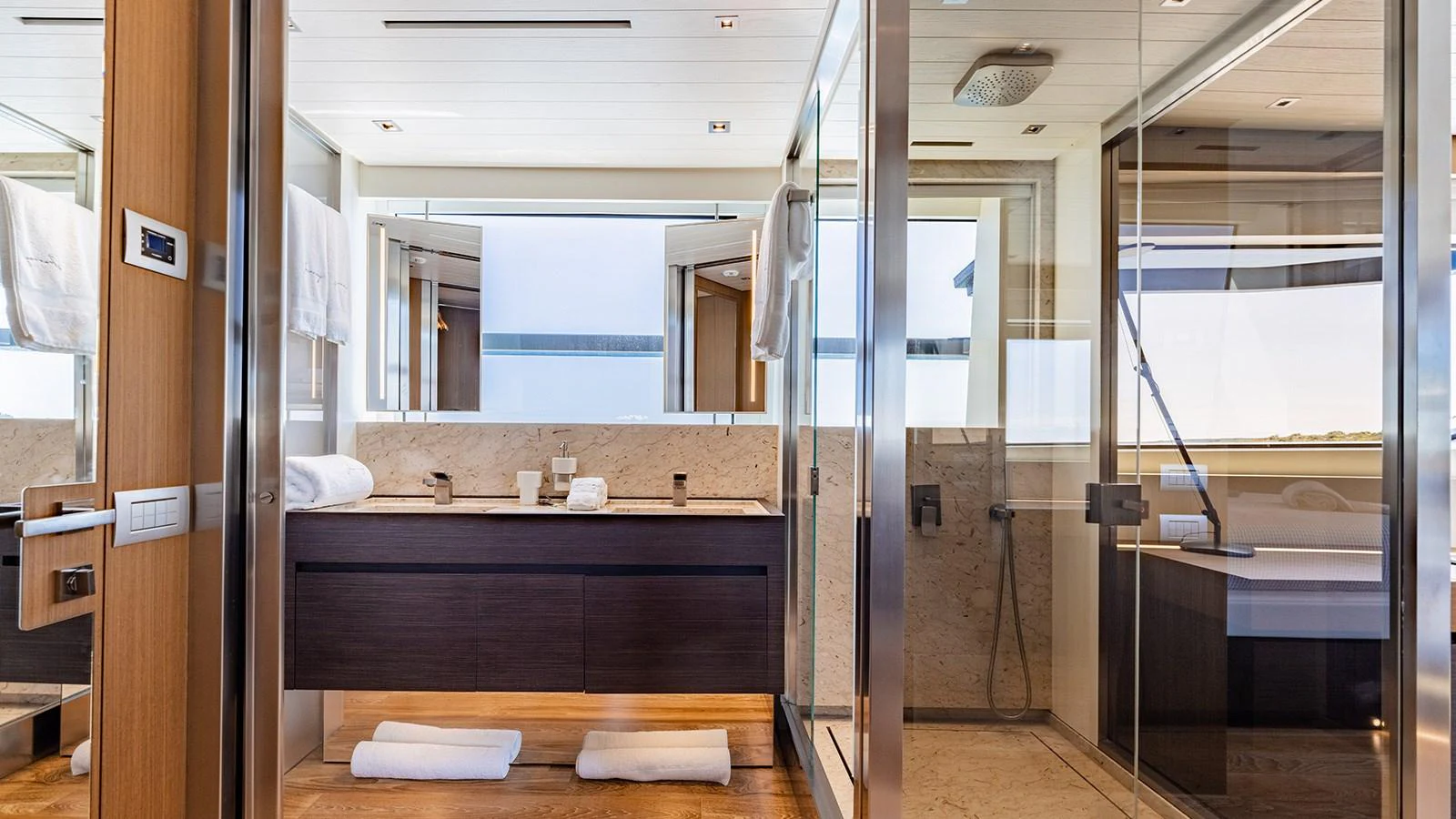 The yacht's bathroom features a modern design with glass shower enclosures and sleek fixtures. aboard JOURNEY Yacht for Sale