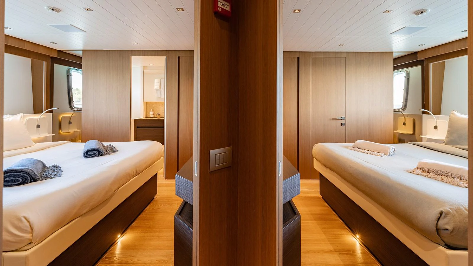 The guest stateroom features twin beds with modern decor and ample natural light. aboard JOURNEY Yacht for Sale