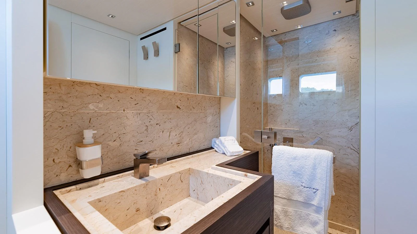 The yacht's bathroom features elegant marble finishes and modern fixtures. aboard JOURNEY Yacht for Sale