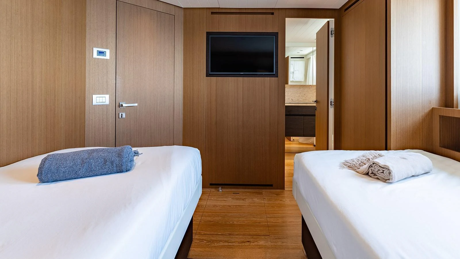 The guest stateroom features twin beds and a modern, minimalist design. aboard JOURNEY Yacht for Sale