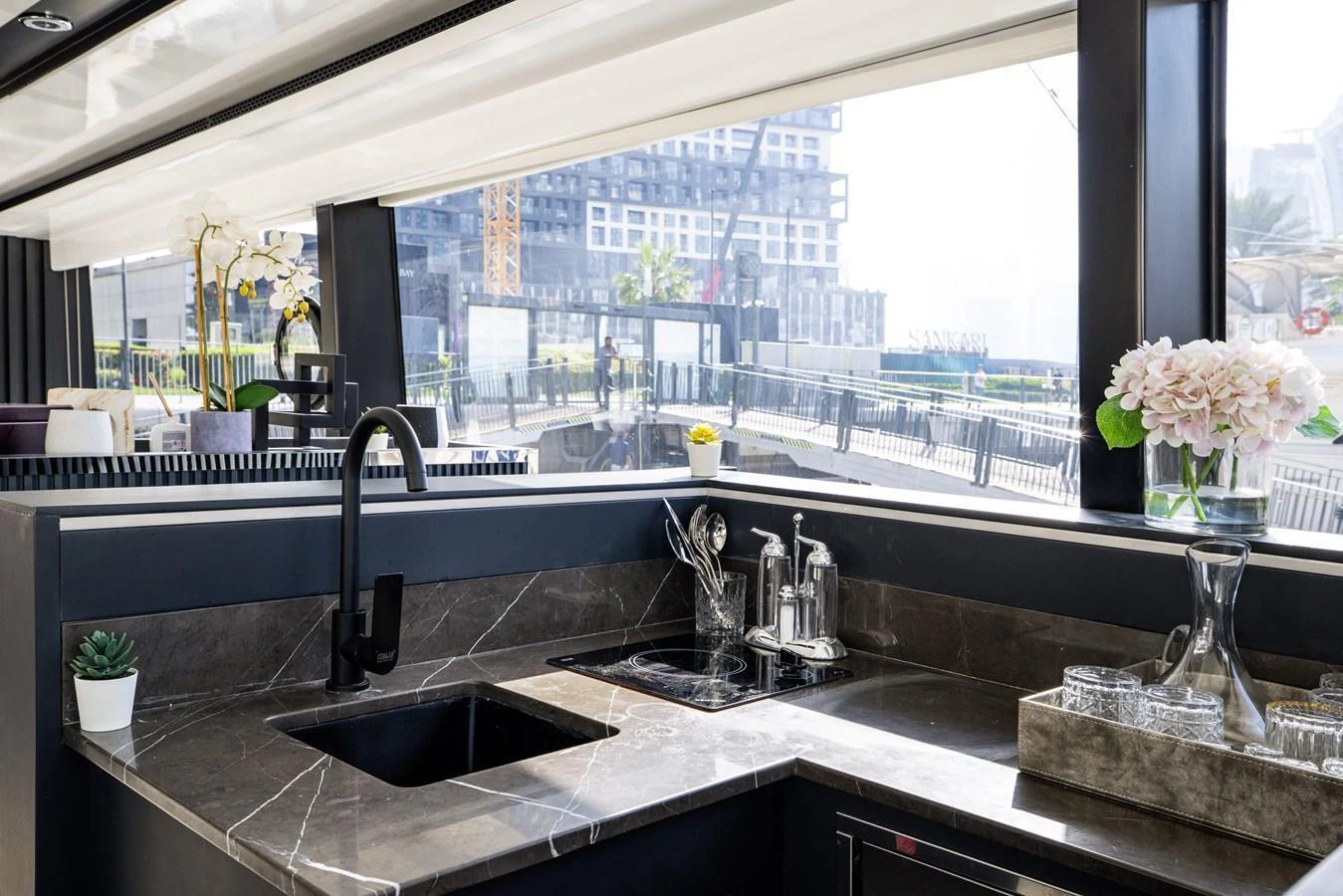 The modern galley features sleek countertops and large windows for ample natural light. aboard AL SULTAN Yacht for Sale