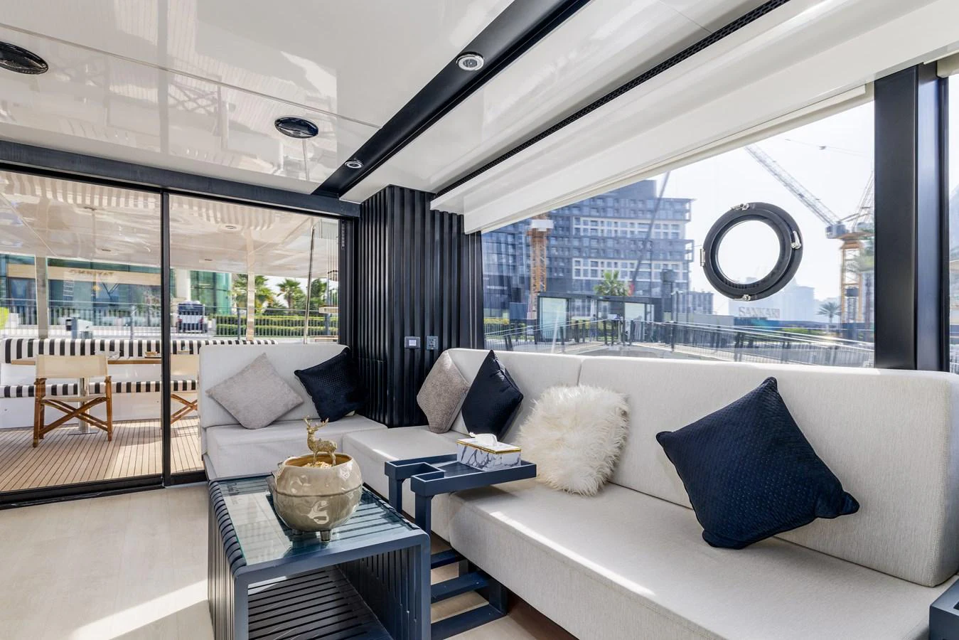The salon features a modern and comfortable seating area with large windows offering plenty of natural light. aboard AL SULTAN Yacht for Sale
