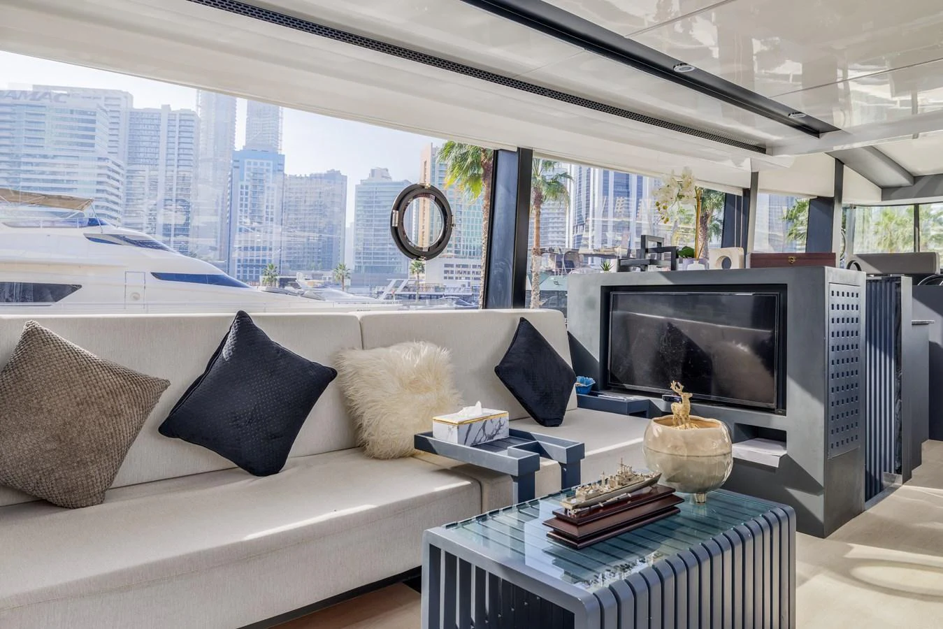 The salon offers a luxurious and comfortable seating area with a view of the marina. aboard AL SULTAN Yacht for Sale