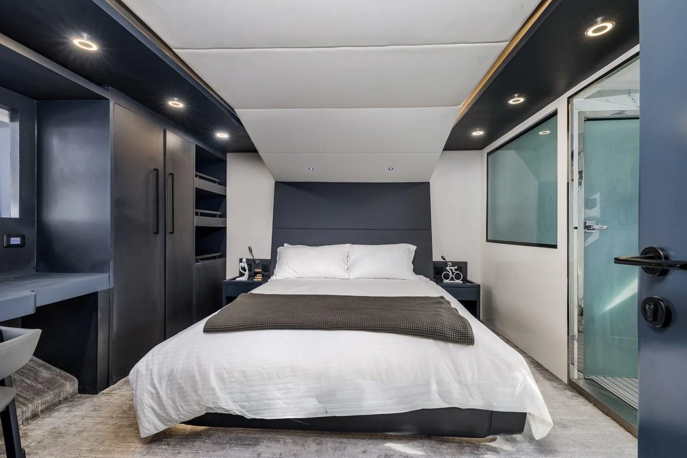 A luxurious stateroom featuring a comfortable bed and modern design elements. aboard AL SULTAN Yacht for Sale