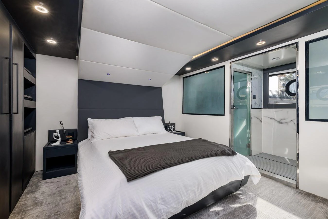 The stateroom features a luxurious bed with modern decor and an ensuite bathroom. aboard AL SULTAN Yacht for Sale