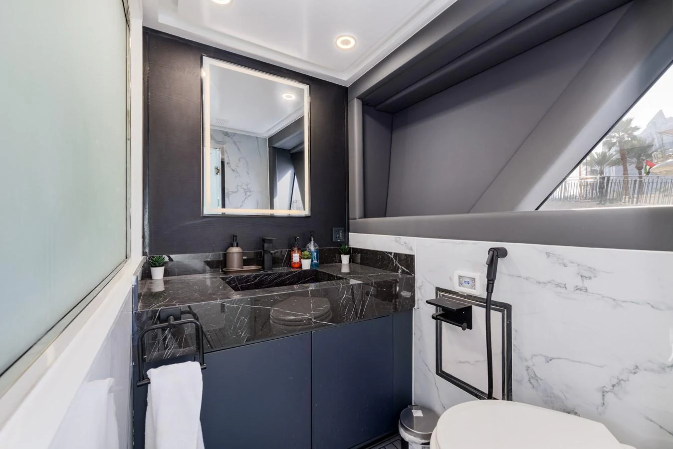 A sleek and modern yacht bathroom with a marble countertop and contemporary fixtures. aboard AL SULTAN Yacht for Sale